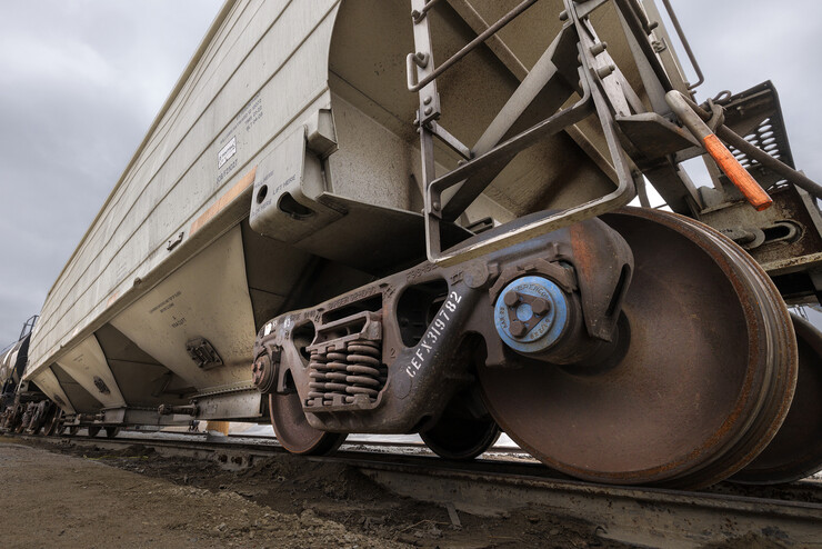 A blue Brenco railcar axle bearing is shown on a railcar.  Each railcar has more than 350 bearings to support the load and keep the wheels turning. This railcar was photographed in the Omaha, Lincoln and Beatirce Railway yard with permission from the railway.