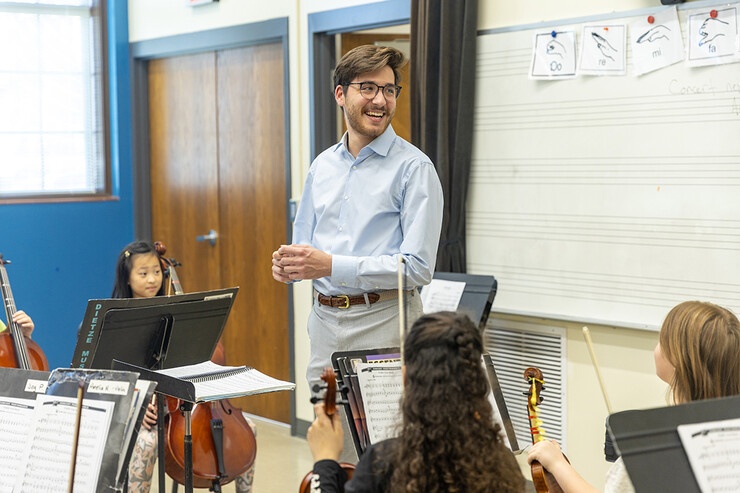 Dameer Gustafson, junior music education major, smiles during the second-year string class.