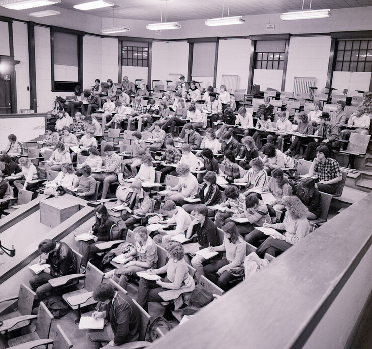 Students take notes in a large, theater-style lecture hall in this photo from 1982.