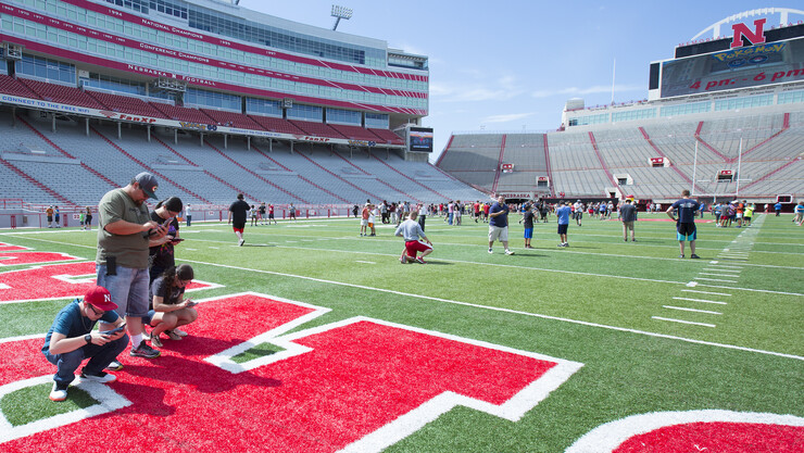 Aaron Shester and his children play Pokémon Go in Memorial Stadium's south endzone on July 14. The event was the first time Shester's children had been inside the stadium.