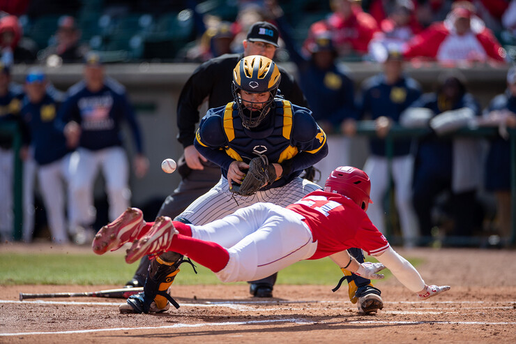 Dillon Galloway captured this photo of a Husker baseball player sliding into home plate ahead of the ball during a game with Michigan.