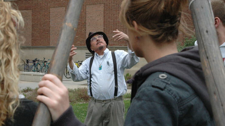 UNL's Mark Awakuni-Swetland gestures as he talks to students during a tipi set-up day outside of Oldfather Hall.
