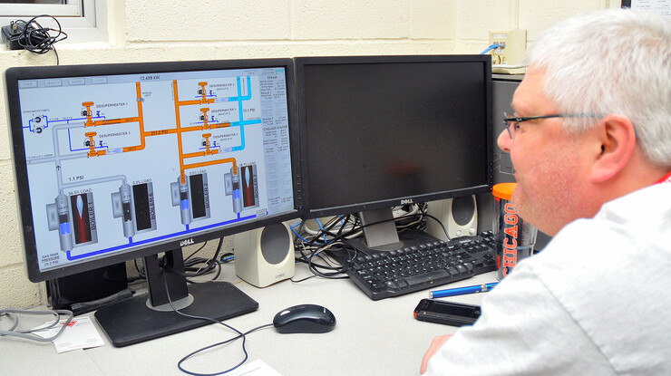 Troy Webb, chief utility operator with Utility Services, monitors boiler operations in the control room of the City Campus utility plant on Nov. 11. Workers monitor operations in the campus utility plants 24 hours a day, seven days a week, 365 days a year.
