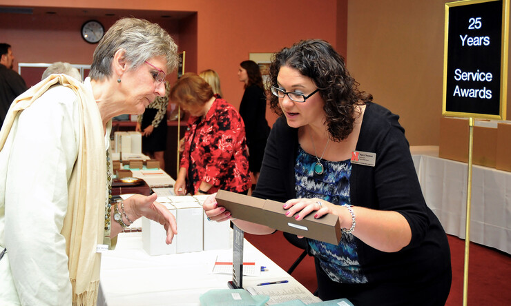 Marcy Neeman (right), a facilitator for Human Resources, helps Christine Marvin, associate professor of special education and communication disorders, find her 25 year service award on Sept. 17. More than 950 UNL employees recevied awards for their years of service to the university.