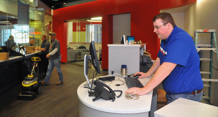 Zach Schriver, a Union Bank employee, sets up a teller station inside the new branch location inside the Nebraska Union on Feb. 24. The branch opens March 2.