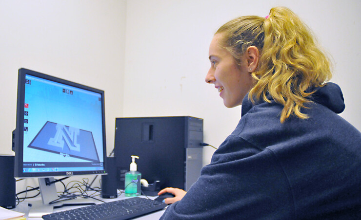 Marissa Clow works on a 3-D design of UNL's academic "N." The design is one of many 3-D models Clow has created for Print Services new 3-D printing option.