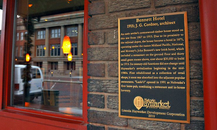 A plaque on the wall outside Lazlo's details the history of the building.