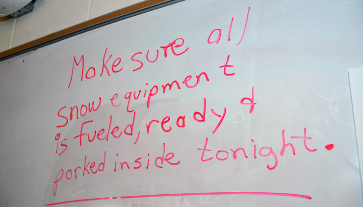 A message on a dry-erase board in Landscape Services City Campus office outlines the order fo the day on Feb. 3 as UNL prepares for a forecasted snow storm.