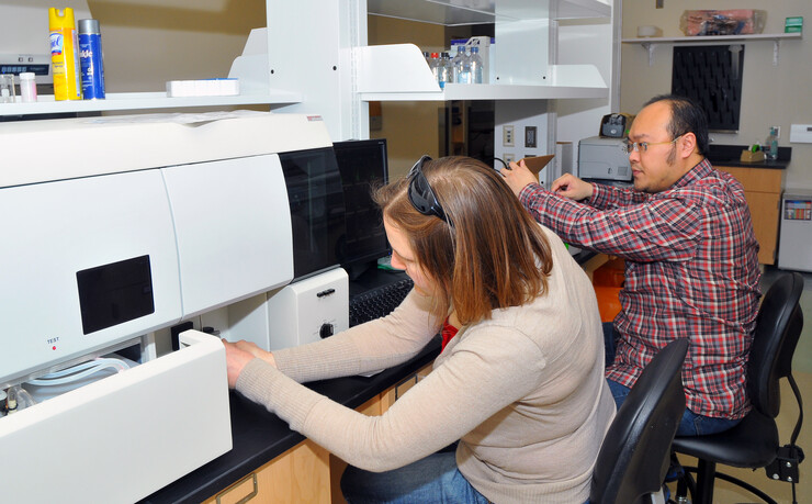 Danielle Shea, lab manager for the Nebraska Center for Virology, and Zhe Yuan, doctoral student, test samples in one of the new labs within the Ken Morrison Life Sciences Research Center.