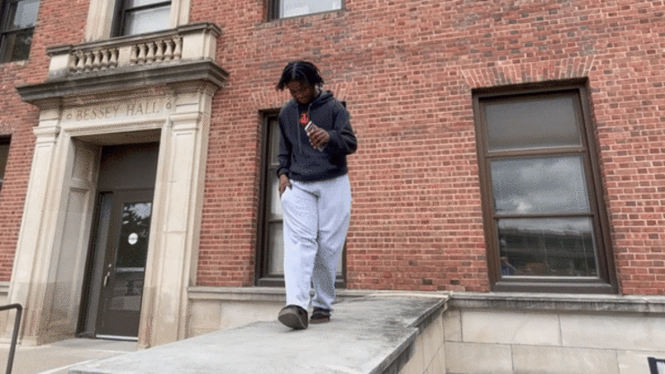 Dismas Nsabiyumva dances at the front entrance to Bessey Hall on Aug. 16. Nsabiyumva felt the need to dance after sitting through a series of orientation presentations. The song that inspired him is "Virgen" by Adolescentes Cancion.