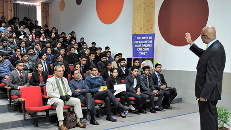 Dipra Jha delivers a Guru Series lecture at Shoolini University in India.