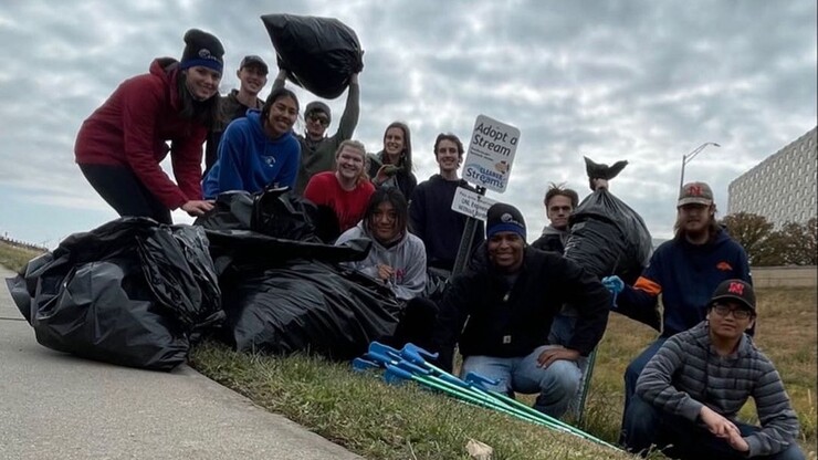 Engineers Without Borders members pose with garbage bags at a community clean up event.
