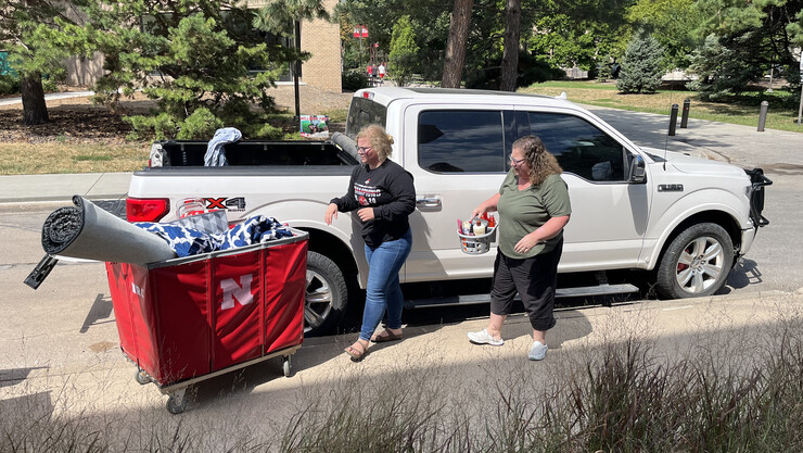 Vickie Ference and her mom, Christie load up carts to take into Vickie's suite in Massengale Residential Center on East Campus.
