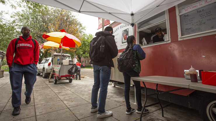 Students start lining up to purchase lunch from food trucks on the Nebraska Union plaza. Due to ongoing construction in the Nebraska Union food court, food trucks will be available on the plaza (weather permitting) this semester.
