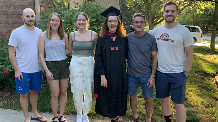 Nebraska's Mikki Sandin stands with her family after earning a degree.