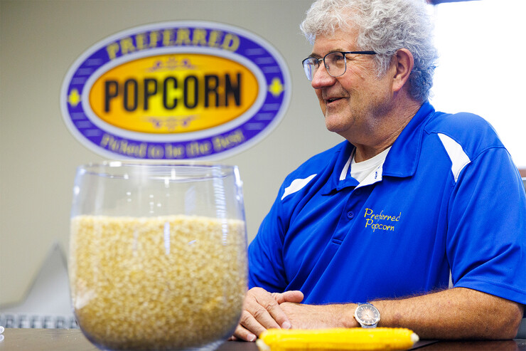 Norm Krug backgrounded by Preferred Popcorn logo