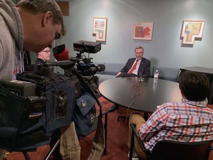 Local media members interview Chancellor Ronnie Green in the Lied Center Green Room following the State of the University address.