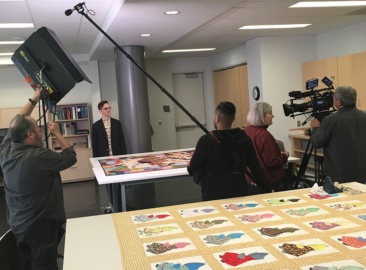 A PBS video crew films a scene in the International Quilt Museum for "Crafts in America" during a visit in March.