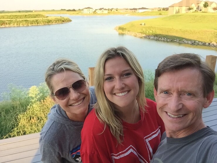 Reilly Pogue with her parents in Lincoln, Nebraska.