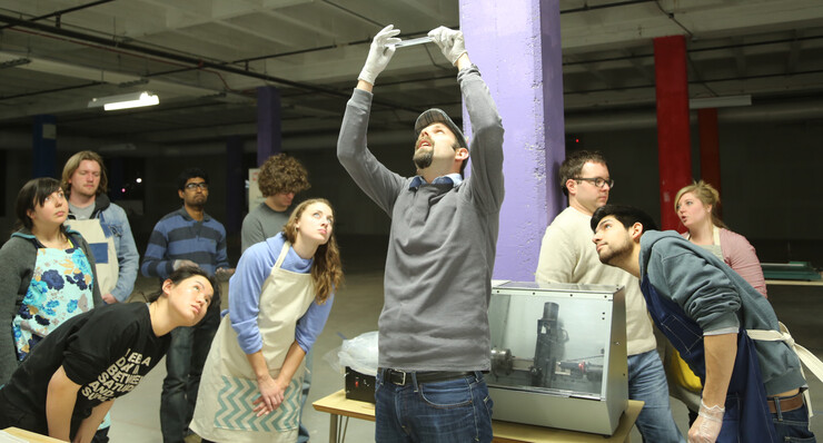 UNL's Stephen Morin examines a soft robot as students look on during a March 4 lab session in Innovation Studio.