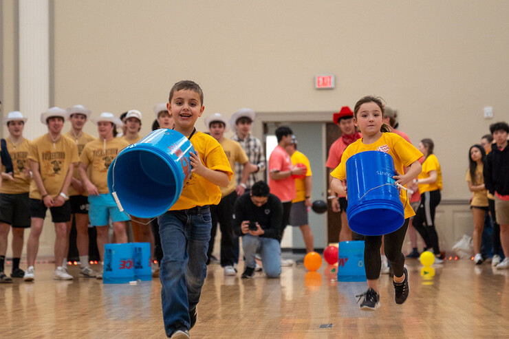 Two miracle kids compete in a bucket race.