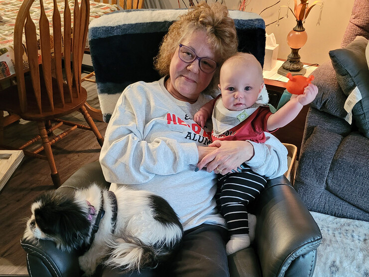 Wendy Kempcke rests in a recliner with a grandchild.