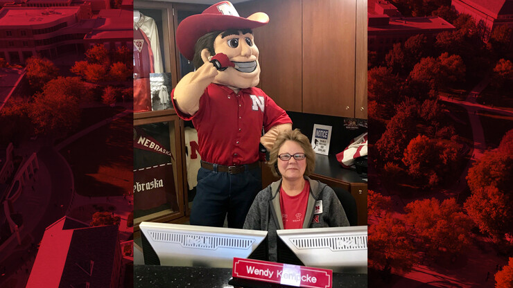 Herbie Husker pays a visit to Wendy Kempcke in the Nebraska Alumni Association.