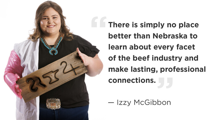 Photo of Izzy McGibbon holding a board with her family's brand and a quote. The quote says, "There is simply no place better than Nebraska to learn about every facet of the beef industry and make lasting, professional connections.”