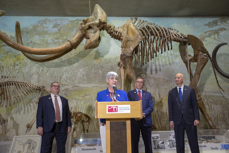 Susan Weller talks during the proclamation event in Morrill Hall on June 14 as (from left) Bob Wilhelm, Ronnie Green and Pete Ricketts look on.