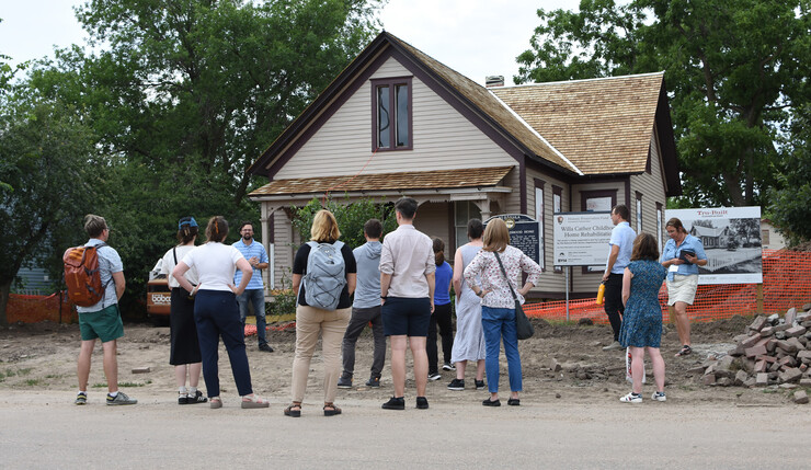 Institute participants gather around Willa Cather's childhood home, which is being restored in Red Cloud.