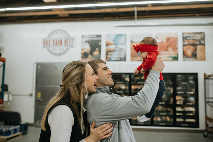 The Klitzs spend time with their daughter, Millie, at the opening of their Oak Barn Beef store in West Point in January.