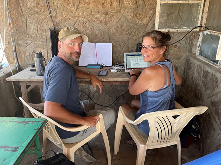Charley Bittle and Chelle Gillan work on plans at the field school in Kenya.