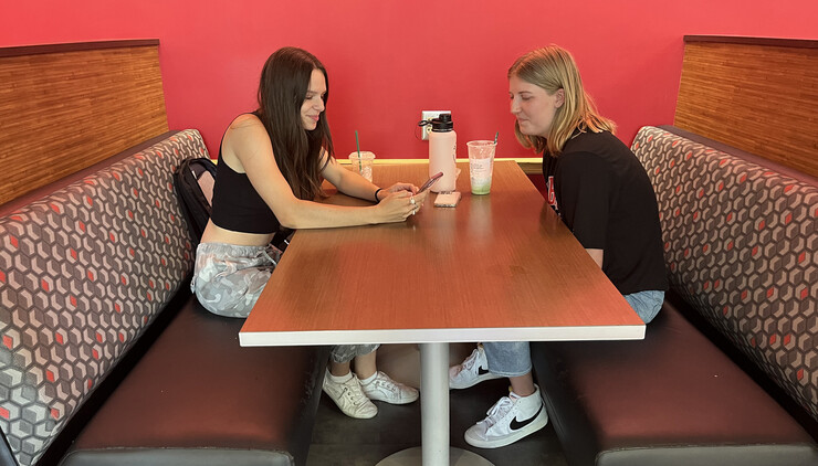 Evelyn Prem (left) and Kaitlyn Richards grabbed coffee from the Nebraska Union Starbucks Aug. 18. Richards, a sophomore, gave first-year student Prem a crash course on campus life.