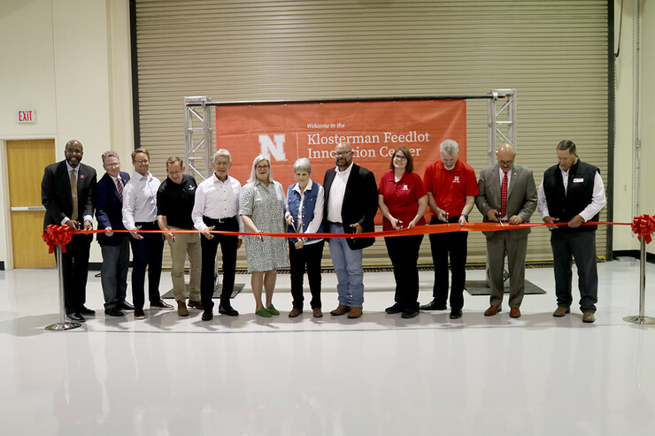 Those cutting the ribbon were (from left) University of Nebraska–Lincoln Chancellor Rodney Bennett; Derek McLean, Agricultural Research Division dean and director; Jason Weller, JBS Foods USA chief global sustainability officer; Mark Jensen, CEO of Farm Credit Services of America; Henry Davis, president/CEO of Greater Omaha Packing Co.; Meg Klosterman Kester; Beth Klosterman; Jack Klosterman; Deb VanOverbeke, Animal Science Department head; Galen Erickson, Nebraska Cattle Industry Professor of animal science; Mike Boehm, NU vice president and Harlan Vice Chancellor for IANR; Doug Zalesky, director of the Eastern Nebraska Research, Extension and Education Center. 