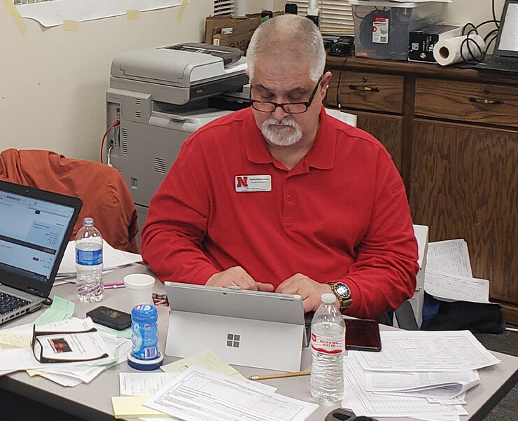 Mark Robertson works on paperwork as part of the emergency response team in Fremont. Robertson was one of four officials selected by the Nebraska Emergency Management Agency to help in Dodge County after flooding in March.