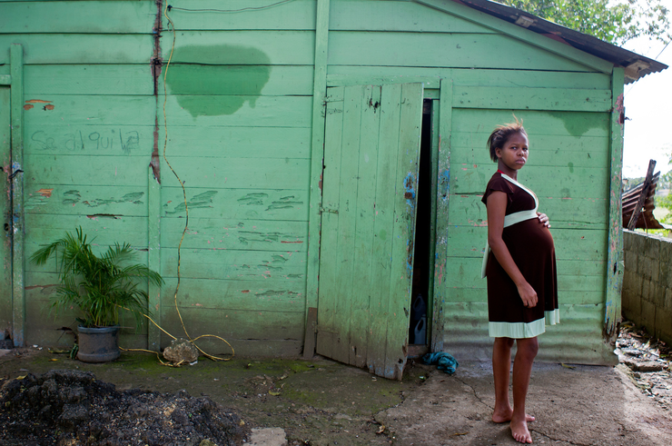 A pregnant teen stands outside a building in the Dominican Republic. Anna Reed explored teen pregnancy in the Dominican Republic. Read more at http://go.unl.edu/80bu.