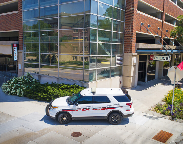 A university police vehicle sits in front of the UNLPD station.