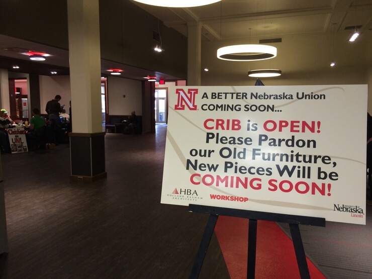 A sign outside of The Crib in the Nebraska Union announces that the space is open and that new furniture will be coming to the space.