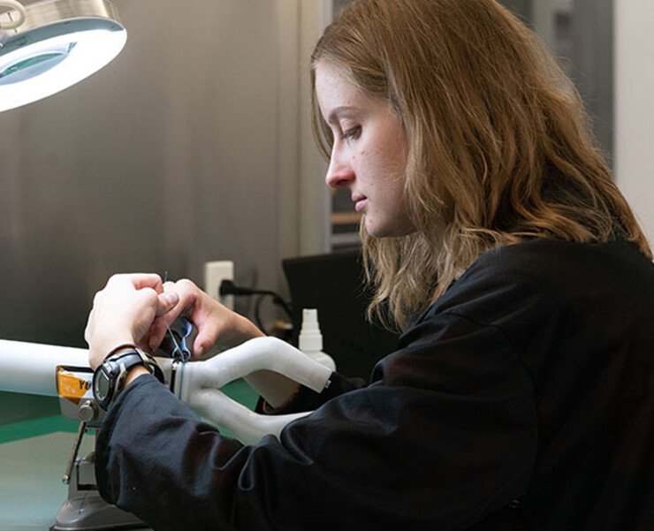 Husker engineering graduate student Rachael Wagner adjusts the MIRA surgical robot.