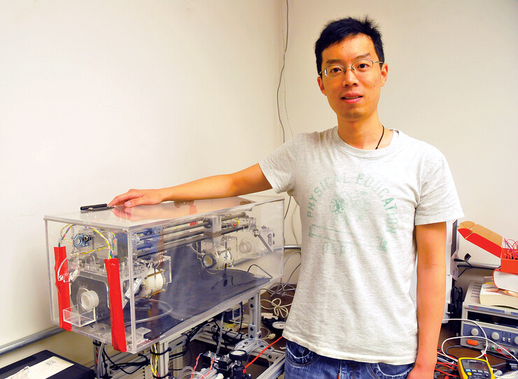 Graduate student Wanchuan Xie stands next to a simulator that allowed the researchers to test their mechanism prior to its placement in a live pig.