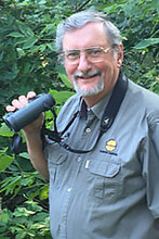 Robert Zink holding a pair of binoculars