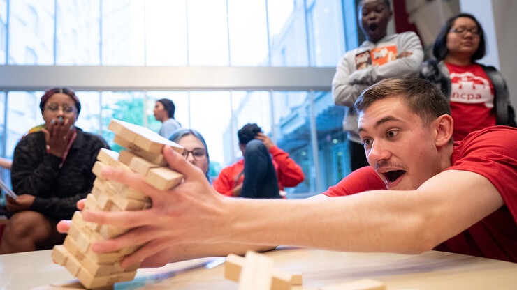 John Clark (right) reacts after tipping a Jenga tower during the Nebraska College Preparatory Academy’s Science Camp inside Abel Hall on June 9.