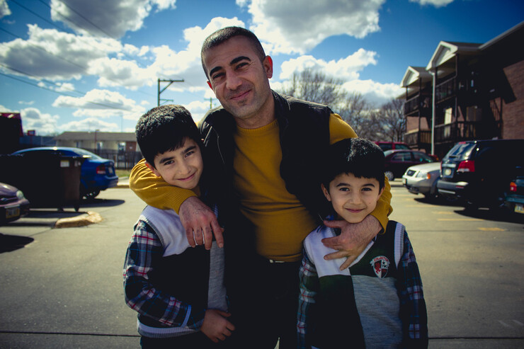 A Yazidi family from northern Iraq smiles after their first day of school in Lincoln