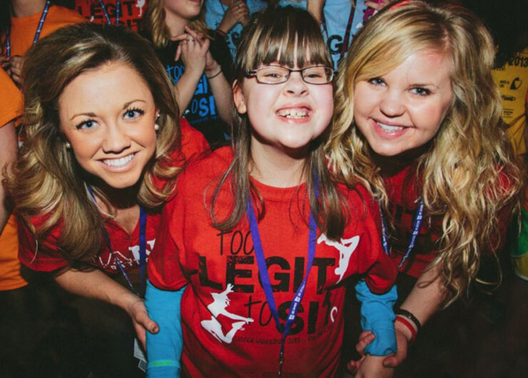 UNL students pose with a child during the 2013 UNL Dance Marathon. Proceeds from the dance benefit the Children's Miracle Network.