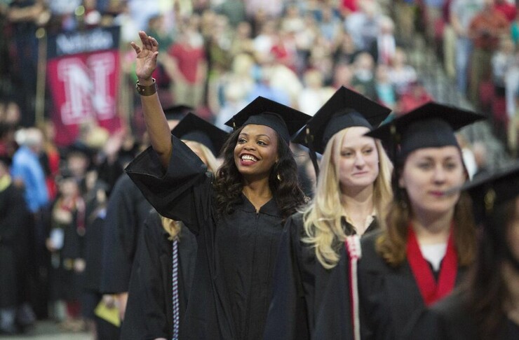 Latoyce Green waves to family and friends during 2014 commencement ceremonies. UNL is one of the nation’s best four-year institutions in substantially improving graduation rates for African-American students, a newly released national report shows.