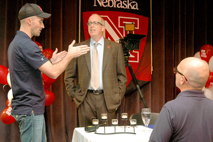 During a break in filming, (from left) Christian Nelson, director of photography; David Manderscheid, dean of Arts and Sciences; and Daniel Patterson, senior producer; discuss how dinner service will work in the “Dining with the Dean” episode. The reality TV episode was filmed in 2011.