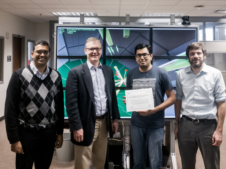 A paper co-authored by (from left) Byrav Ramamurthy, David Swanson, Deepak Nadig Anantha, and Brian Bockelman earmed a top paper award during an IEEE conference in India.