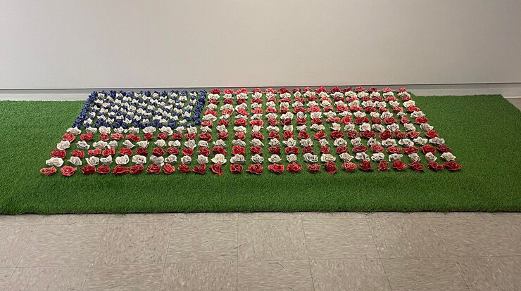 A flag is made entirely of ceramic flowers.