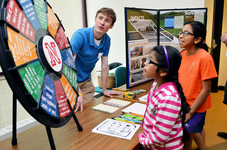 Claudia Carrillo (center) and Paula Carrillo (right) learn about drought from Jake Petr, a meteorology student in the School of Natural Resources, during the 16th annual Weatherfest in April 2016 at Hardin Hall. The 2017 event is April 1 at the Nebraska Innovation Campus Conference Center.