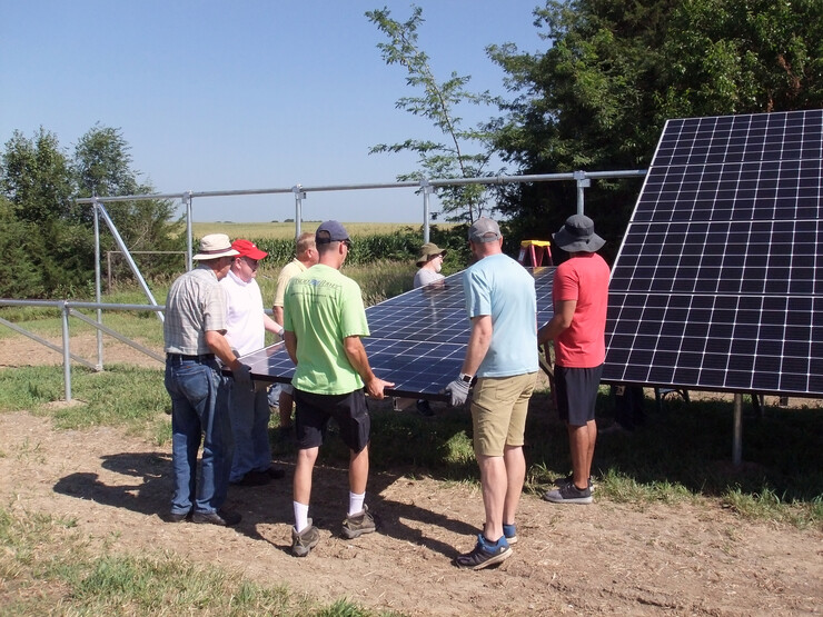 Workshop participants help assemble a solar photovoltaic array at a hands-on workshop during summer 2018.